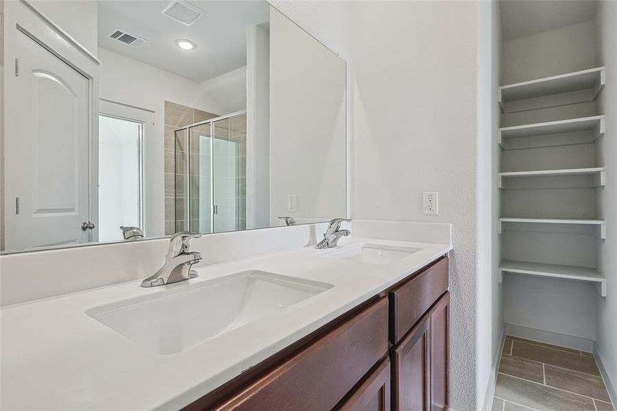 Bathroom featuring an enclosed shower and vanity