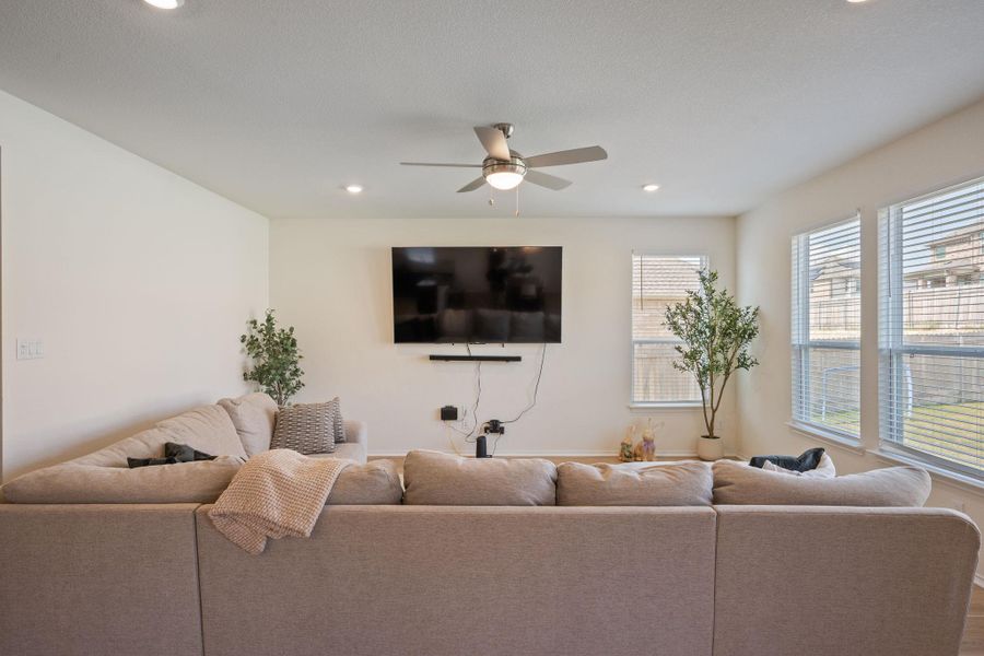 Living room featuring ceiling fan, recessed lighting, and wood finished floors