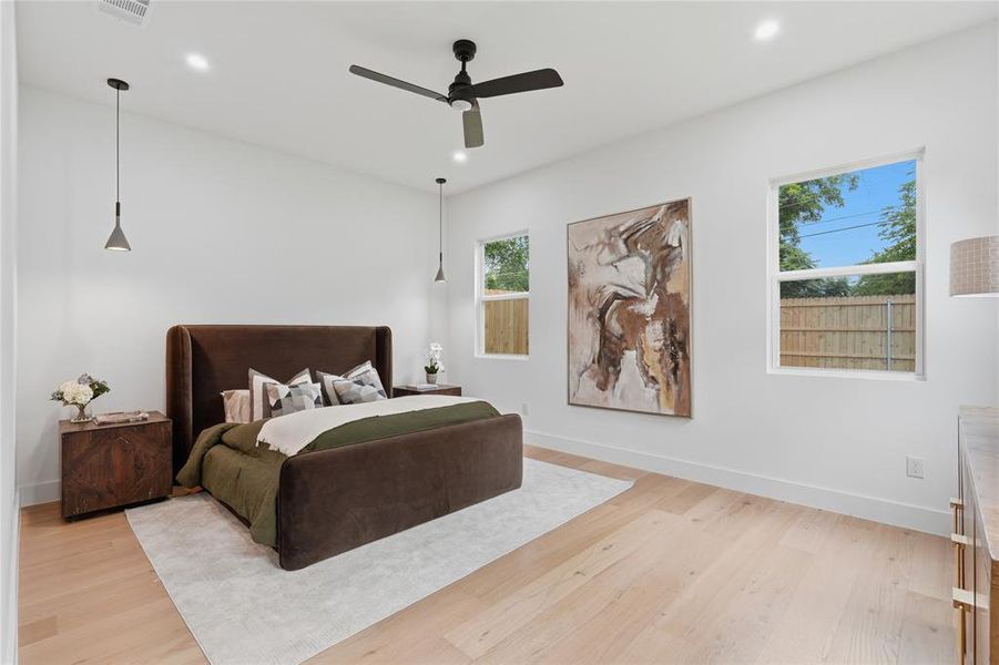 Spacious room featuring light wood-finish flooring, white walls, and recessed lighting Spacious room featuring light wood-finish flooring, white walls, and recessed lighting