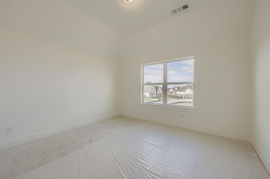 Carpeted spare room with baseboards