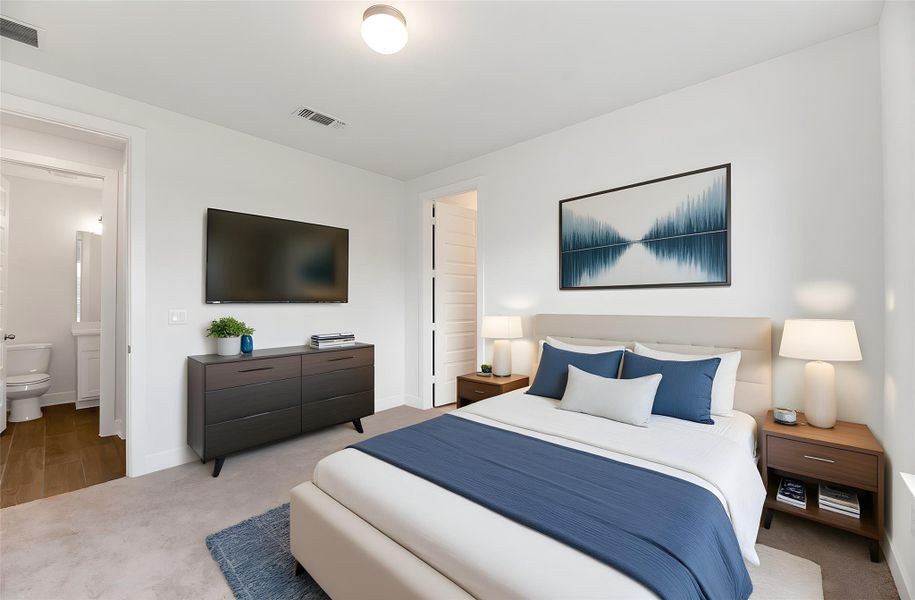 Bedroom with carpet flooring and ensuite bath Bedroom with carpet flooring and ensuite bath