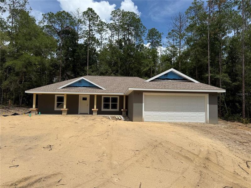 Front exterior of a new home in , Dunnellon, FL, highlighting curb appeal (Image 1).