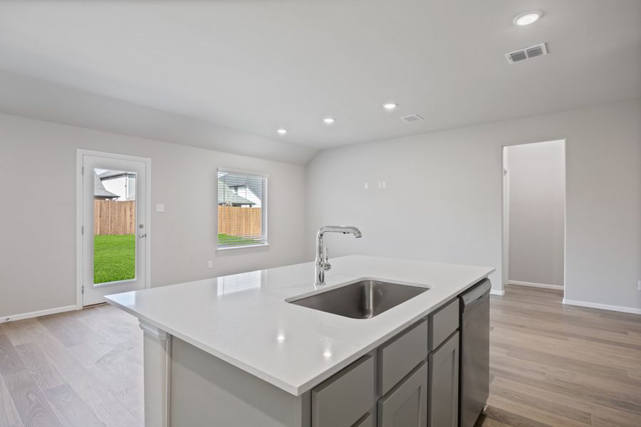 Kitchen in the Hadley home plan by Trophy Signature Homes – REPRESENTATIVE PHOTO