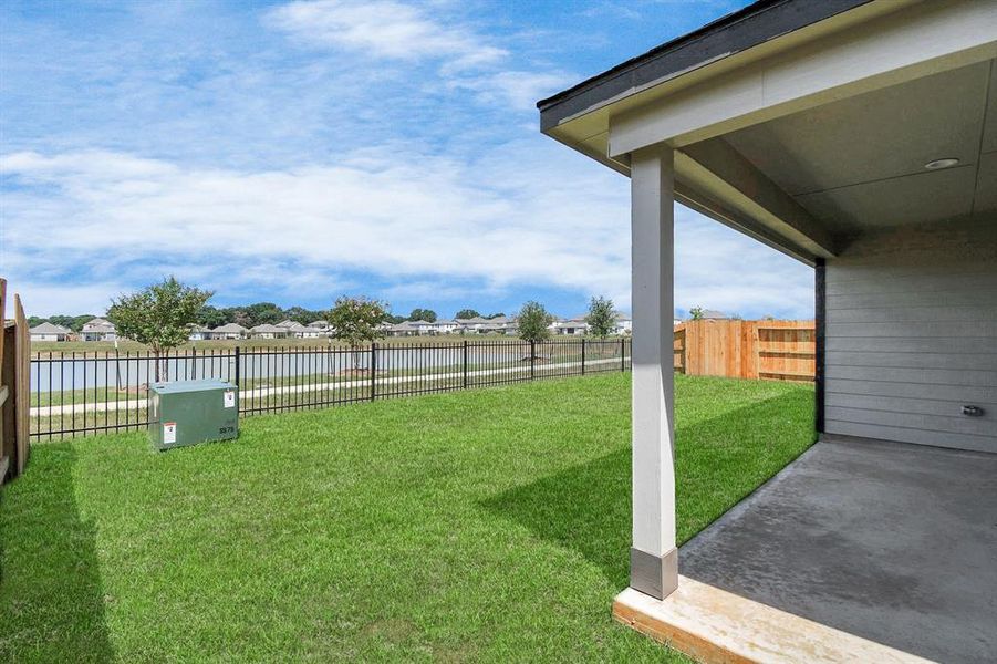 Experience outdoor living at its finest on this expansive covered patio with lake views, thoughtfully designed for BBQs and delightful outdoor dining