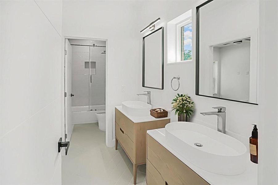 Bathroom with two vanities and shower / washtub combination