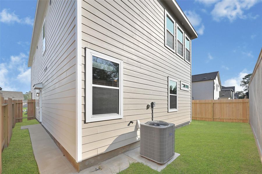 Walkway leads around the side of the home. Please note: The image is not the actual home; it is a home with the same floor plan in the neighborhood.