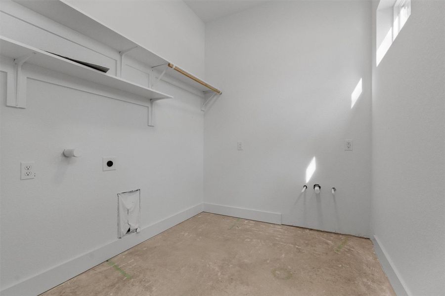 Laundry room featuring unfinished concrete flooring, electric dryer hookup, and gas dryer hookup Laundry room featuring unfinished concrete flooring, electric dryer hookup, and gas dryer hookup