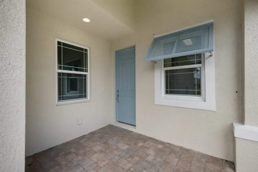 Exterior details and patio area of a home in Reflection Villas at Watercolor Place, Bradenton (Image 3).