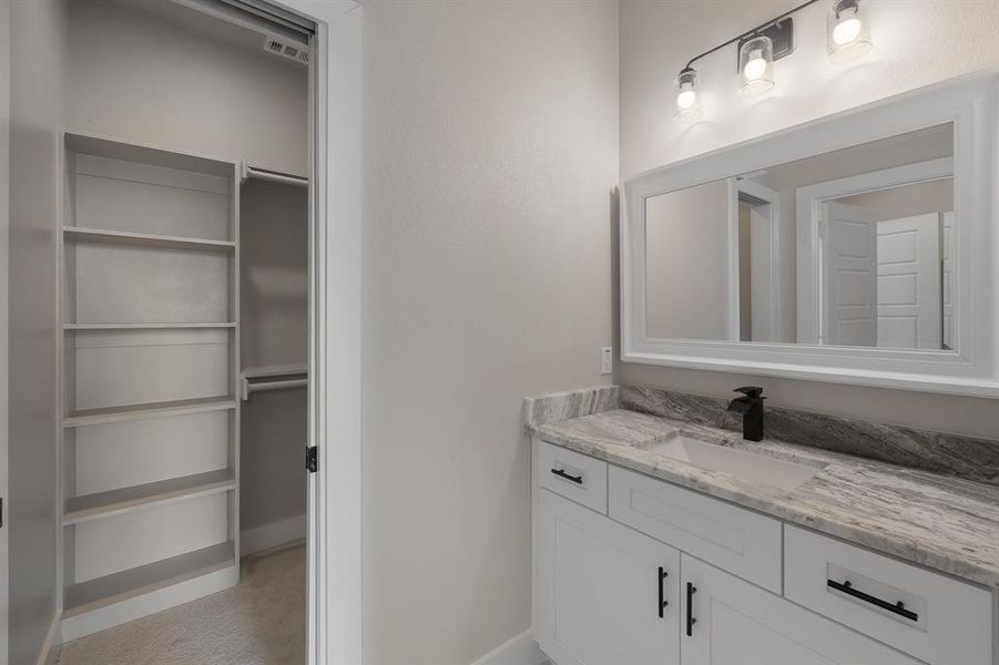 Bathroom with vanity and baseboards