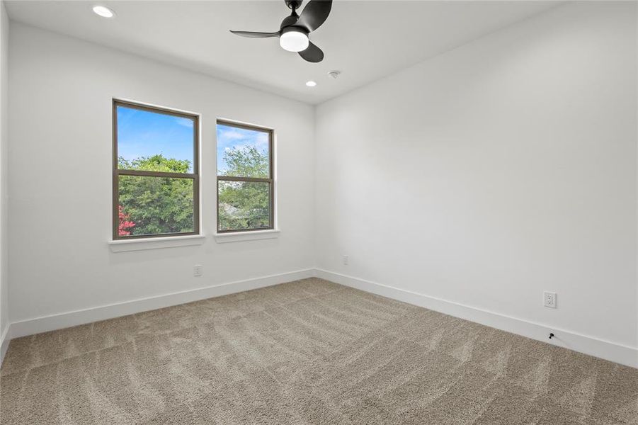 Unfurnished room featuring carpet floors and ceiling fan