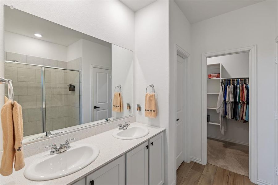 Bathroom featuring vanity, hardwood / wood-style floors, and an enclosed shower