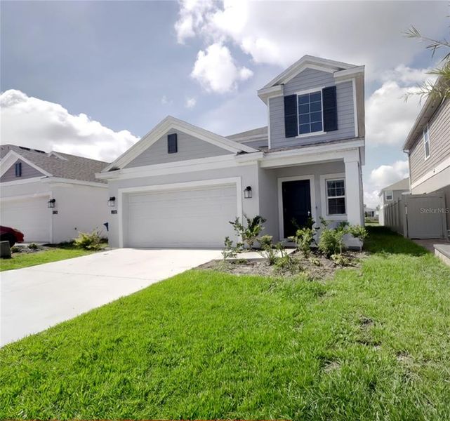 Front exterior of a new home in , Davenport, FL, highlighting curb appeal (Image 1). Front exterior of a new home in , Davenport, FL, highlighting curb appeal (Image 1).
