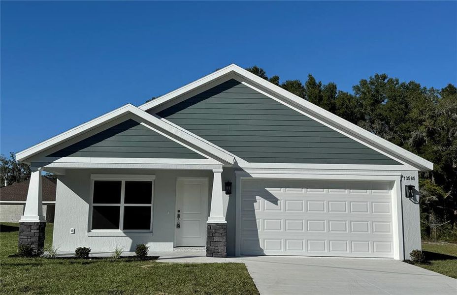 Front exterior of a new home in , Dunnellon, FL, highlighting curb appeal (Image 1).