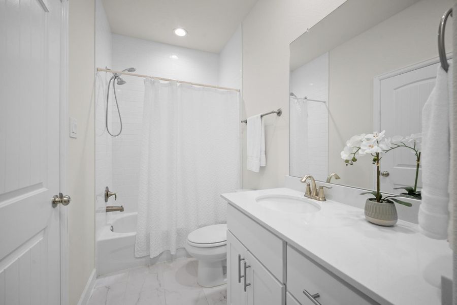 A second angle on the hall bath shows the full tub surround, quartz vanity, and brushed nickel fixtures — clean, bright, and move-in ready. A second angle on the hall bath shows the full tub surround, quartz vanity, and brushed nickel fixtures — clean, bright, and move-in ready.