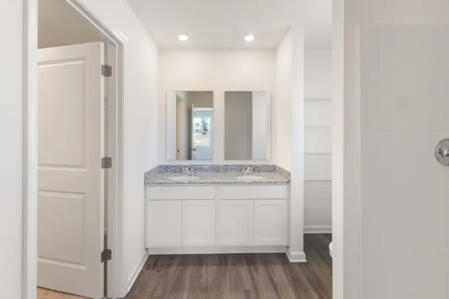 A bathroom with white walls.