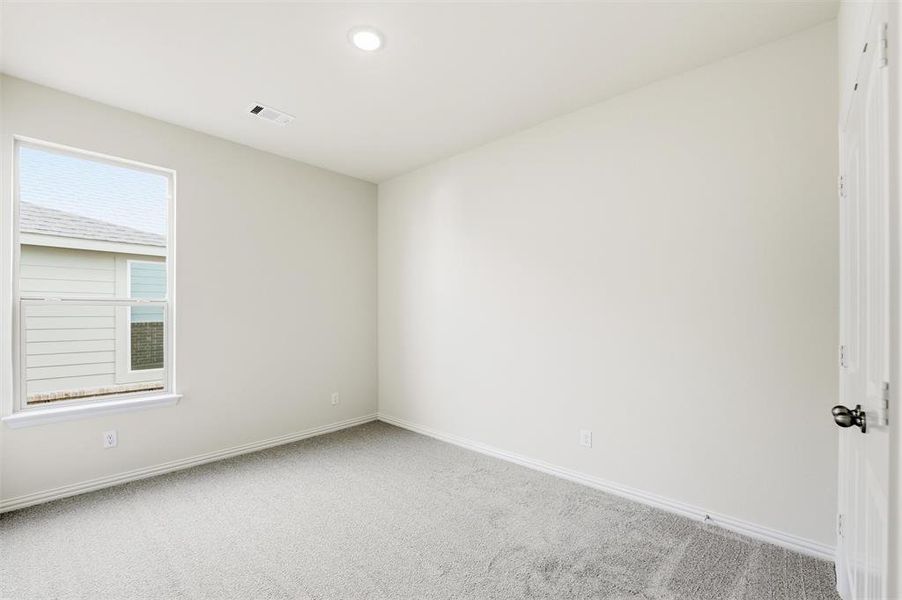 Carpeted empty room featuring baseboards and recessed lighting