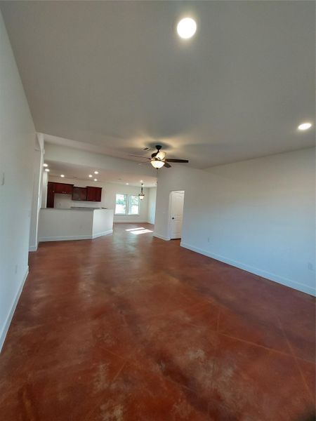 Unfurnished living room featuring concrete floors, recessed lighting, and ceiling fan