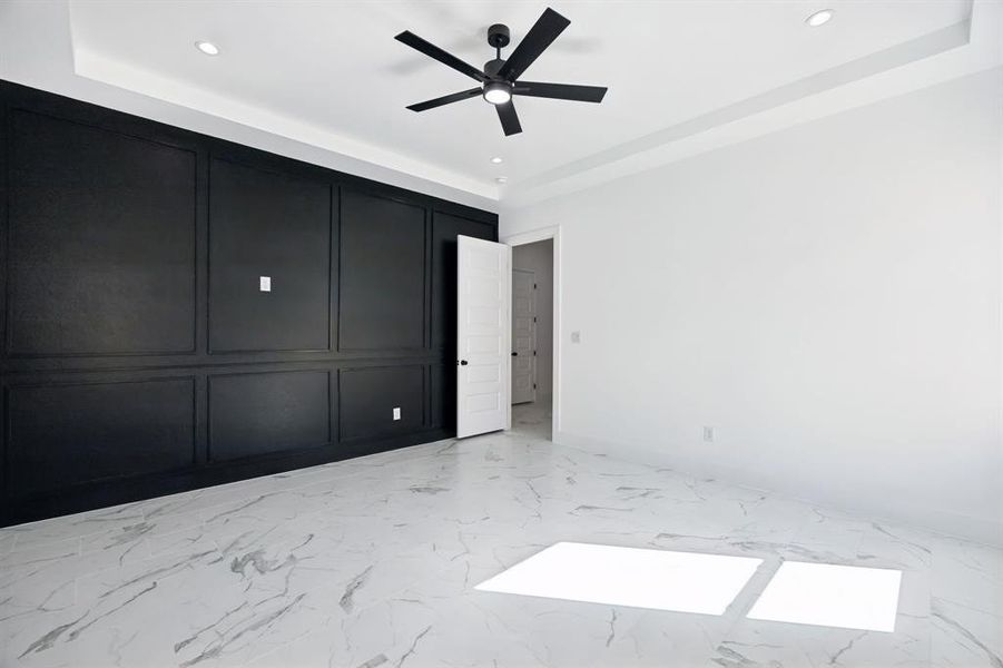 Unfurnished bedroom with light marble finish floors, ceiling fan, and recessed lighting