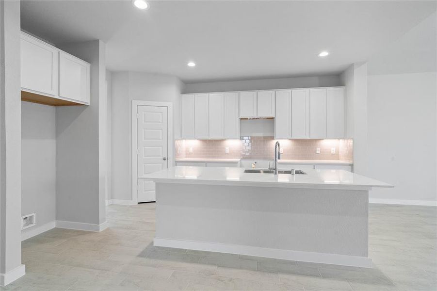 This kitchen is by far any chef’s dream! This spacious kitchen features high ceilings, white stained wood cabinets, quartz countertops, SS appliances, modern tile backsplash, recessed lighting, extended counter space for breakfast bar, and a walk-in pantry all overlooking your huge family room.