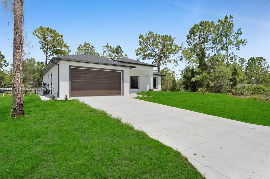 Front exterior of a new home in , Lehigh Acres, FL, highlighting curb appeal (Image 1).