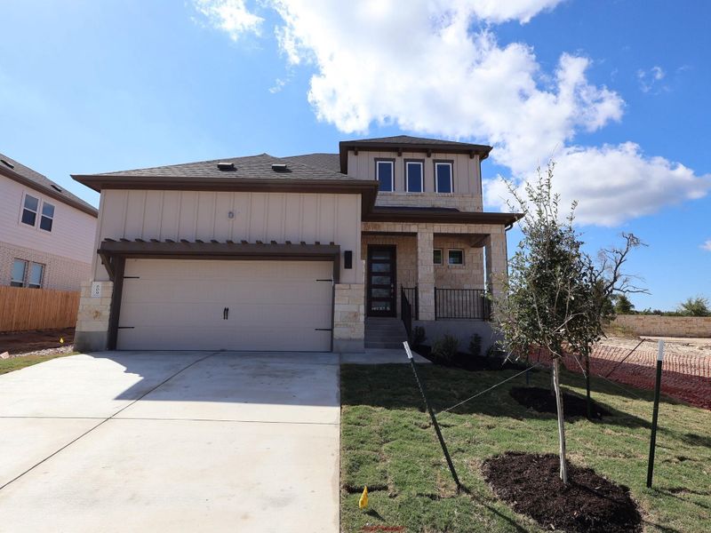 Front exterior of a new home in Marble Creek Crossing, Austin, TX, highlighting curb appeal (Image 2). Front exterior of a new home in Marble Creek Crossing, Austin, TX, highlighting curb appeal (Image 2).