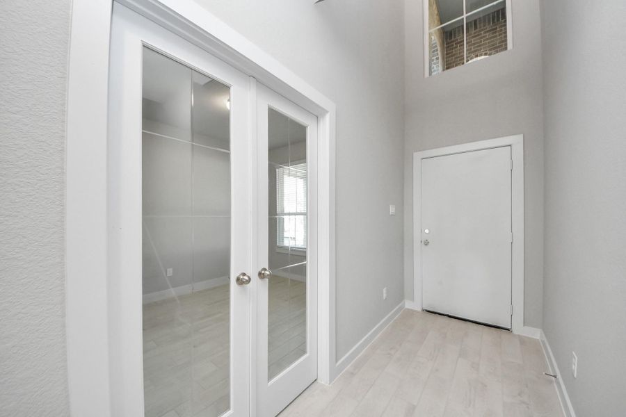 As you step into the threshold of this luxurious home, you'll soon be welcomed by an elegant glass door (to be installed). Inside, soaring ceilings amplify the spaciousness, while the refined wood-look tile flooring and oversized baseboards exude sophistication and charm. Sample photo of completed home with similar floor plan. Actual colors and selections may vary.