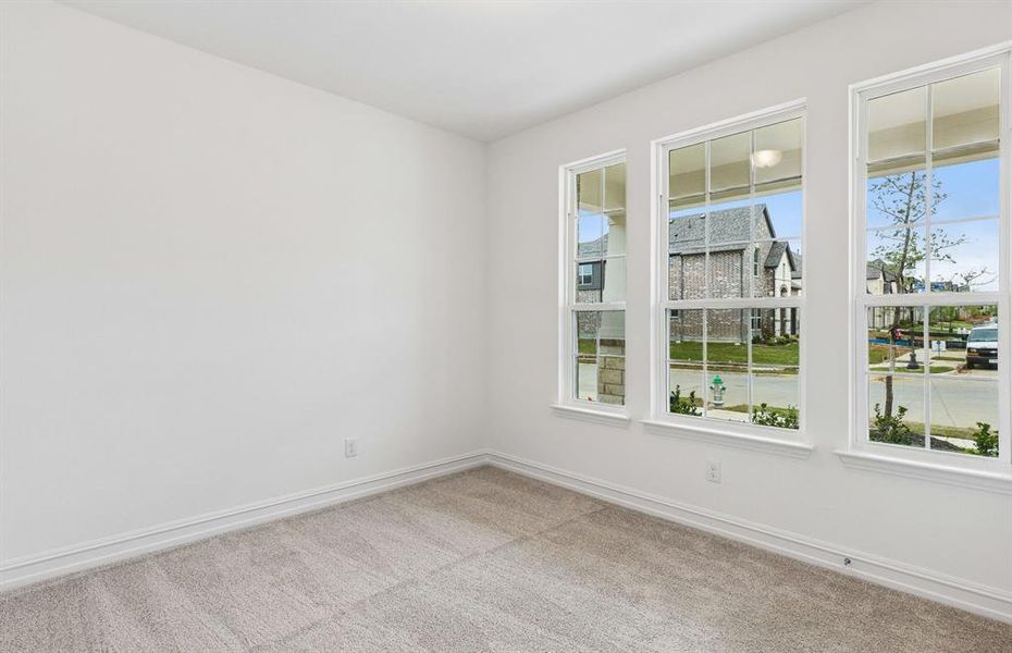 Secondary bedroom off home entry with large windows
