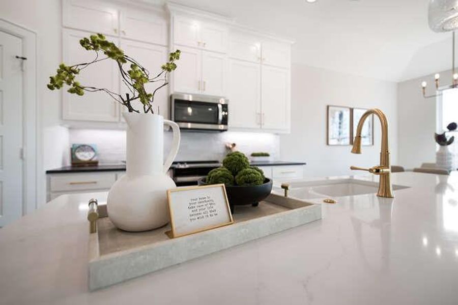 Kitchen area featuring sink, white cabinets, and microwave Kitchen area featuring sink, white cabinets, and microwave