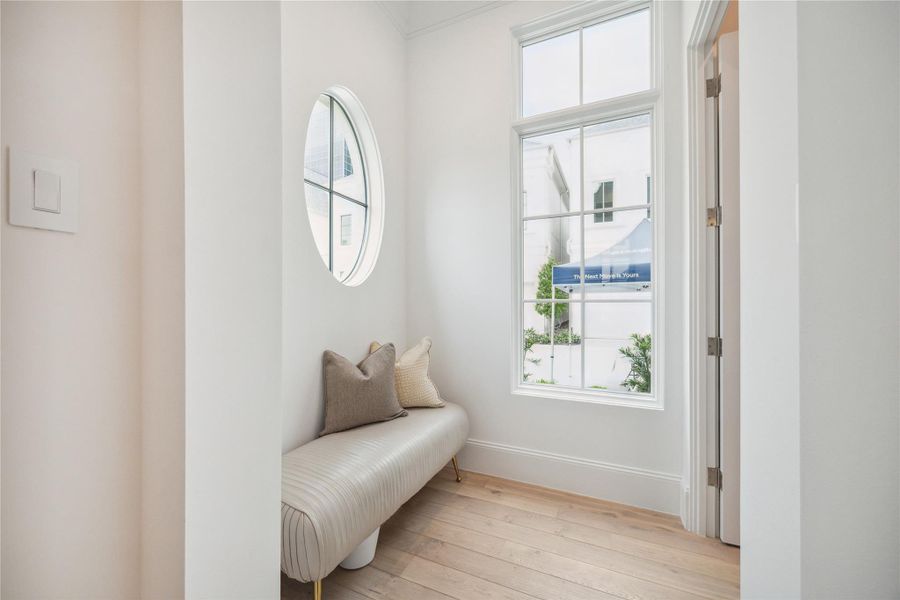 Directly off the entry is this landing area. This space is adorned with windows to allow for additional lighting to fill the foyer. The powder bath can be accessed from this space to allow for privacy. **Photo is of another home in the community and for information purposes only. Buyer to verify all details.** Directly off the entry is this landing area. This space is adorned with windows to allow for additional lighting to fill the foyer. The powder bath can be accessed from this space to allow for privacy. **Photo is of another home in the community and for information purposes only. Buyer to verify all details.**