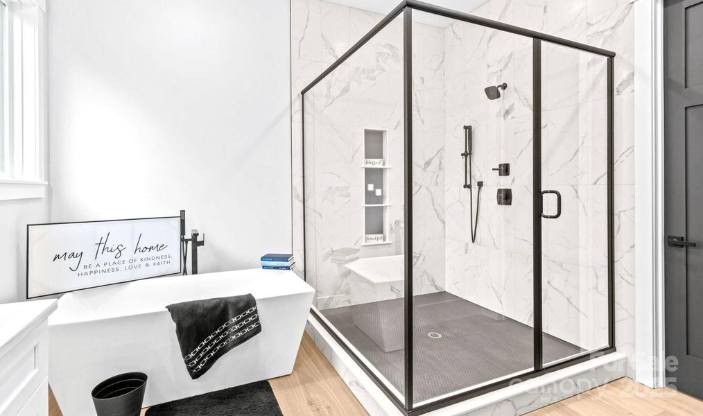 Main Bath with large walk in tiled Shower & Roman soaking Tub.