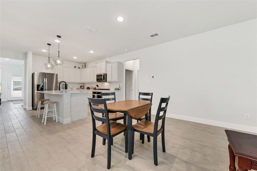 Dining area featuring light wood-type flooring and recessed lighting Dining area featuring light wood-type flooring and recessed lighting