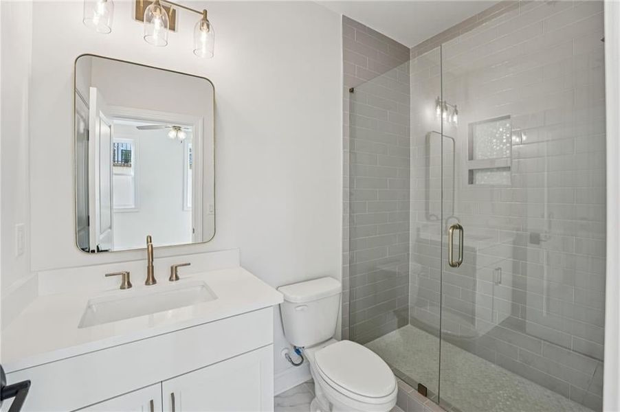 Bathroom with vanity and a shower stall Bathroom with vanity and a shower stall