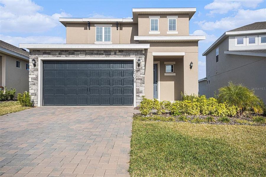 Front exterior of a new home in Hills of Minneola, Minneola, FL, highlighting curb appeal (Image 19).