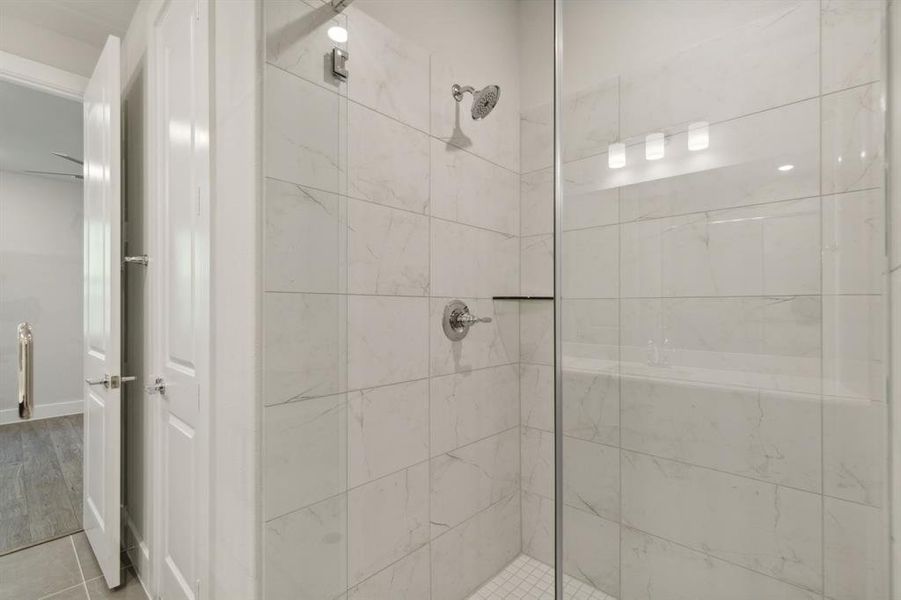 Primary Bathroom with a walk-in tile shower