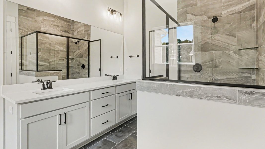 Primary bathroom with dual vanity and glass enclosed shower Primary bathroom with dual vanity and glass enclosed shower