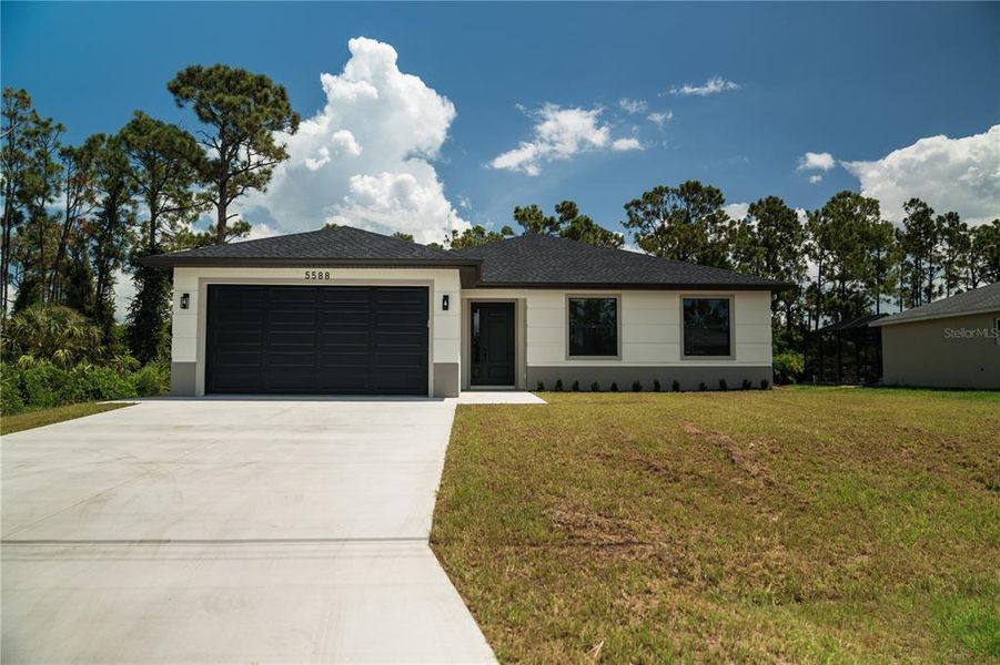 Front exterior of a new home in , North Port, FL, highlighting curb appeal (Image 1).
