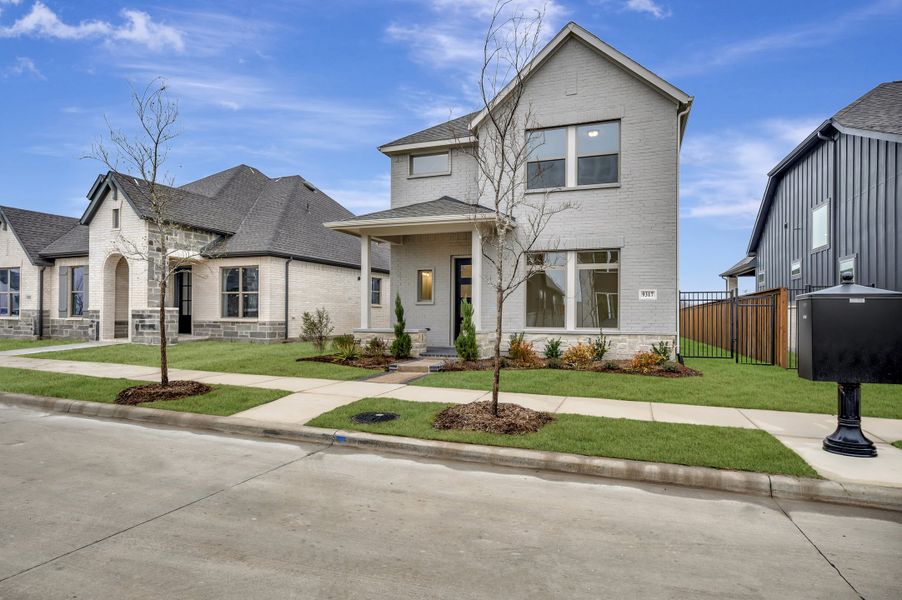 Front exterior of a new home in Talia – Cottage Series, Mesquite, TX, highlighting curb appeal (Image 2). Front exterior of a new home in Talia – Cottage Series, Mesquite, TX, highlighting curb appeal (Image 2).