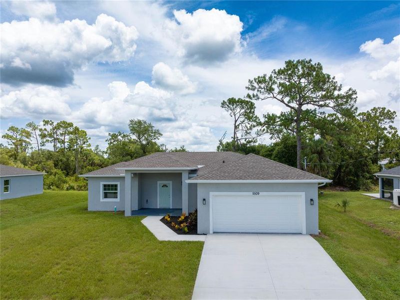 Front exterior of a new home in , North Port, FL, highlighting curb appeal (Image 24). Front exterior of a new home in , North Port, FL, highlighting curb appeal (Image 24).