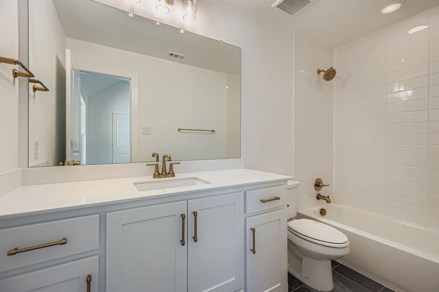 Full bathroom featuring vanity and shower / bath combination Full bathroom featuring vanity and shower / bath combination