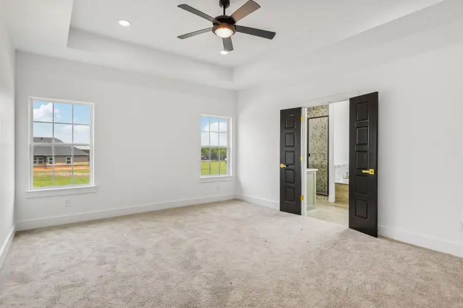 Spare room featuring light carpet, a tray ceiling, a ceiling fan, and recessed lighting Spare room featuring light carpet, a tray ceiling, a ceiling fan, and recessed lighting