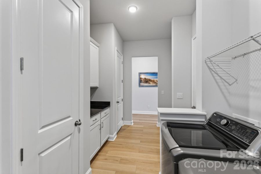 Spacious Laundry Room with linen and storage closets
