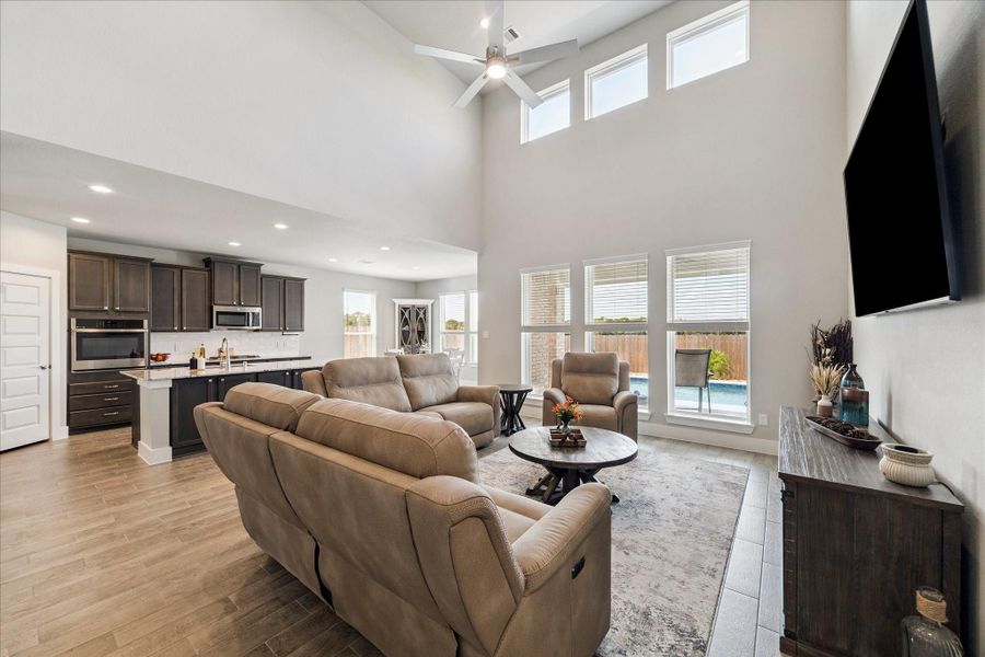 Open living space with soaring ceilings, wall of windows, and seamless flow into the modern kitchen. Open living space with soaring ceilings, wall of windows, and seamless flow into the modern kitchen.