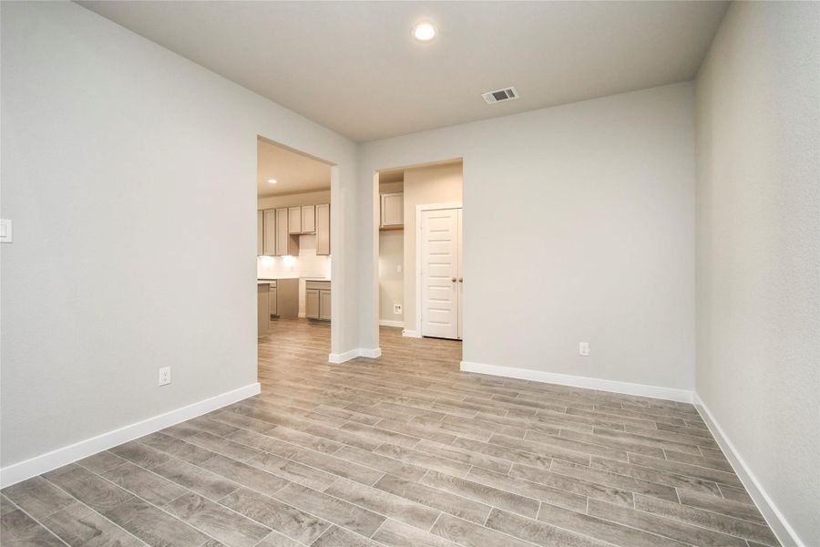 Make memories gathered around the table with your family and friends! This spacious diningroom features elegant flooring, custom paint, and adjacent to family room and kitchen foropen concept feel. Sample photo of completed home with similar floor plan. Actual colors and selections may vary.