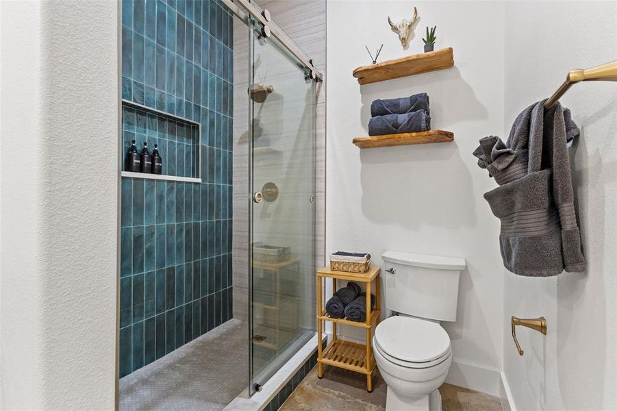 Bathroom featuring toilet and a shower stall