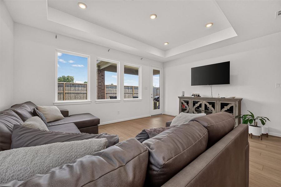 Bright and inviting living room featuring large windows that flood the space with natural light, creating a perfect atmosphere for both relaxation and entertainment.