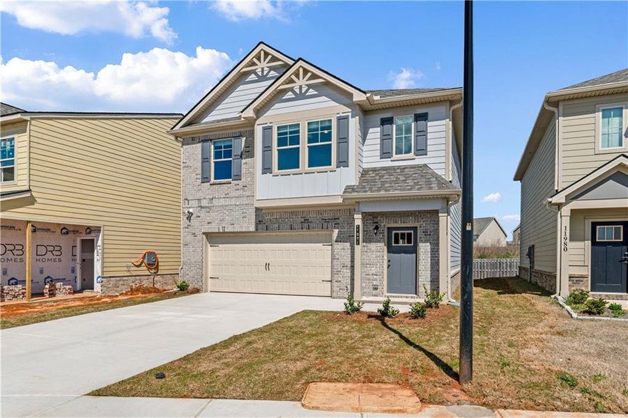 Front exterior of a new home in Towne Center, Hampton, GA, highlighting curb appeal (Image 2). Front exterior of a new home in Towne Center, Hampton, GA, highlighting curb appeal (Image 2).