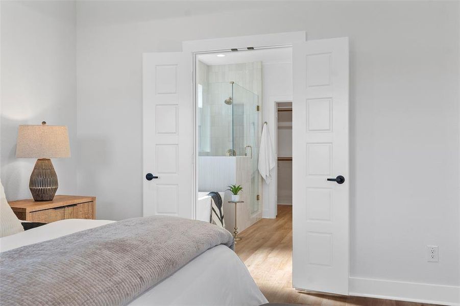 Bedroom with wood finished floors and baseboards