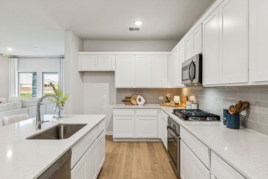 Kitchen in the Oscar home plan by Trophy Signature Homes – REPRESENTATIVE PHOTO
