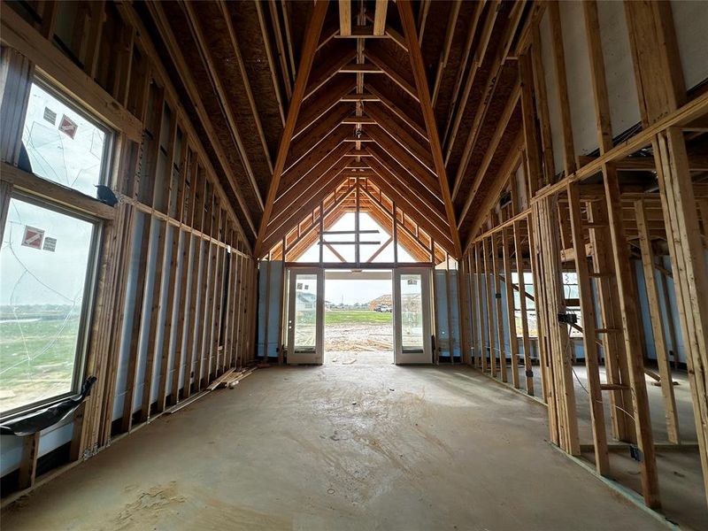 The gorgeous point vaulted ceiling elevates the Family Room with oversized windows allowing for plenty of natural light.