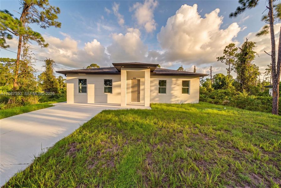 Front exterior of a new home in , Lehigh Acres, FL, highlighting curb appeal (Image 22).